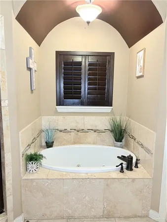 a bathroom with a bathtub and shower