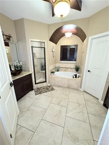 a large bathroom with a sink a large mirror and a shower