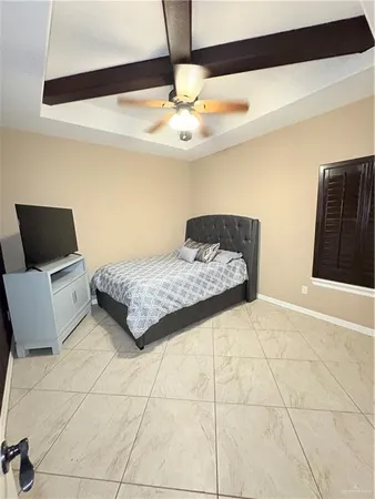 a living room with a bed furniture and a ceiling fan