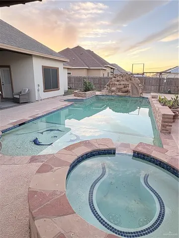 a swimming pool with outdoor seating and yard