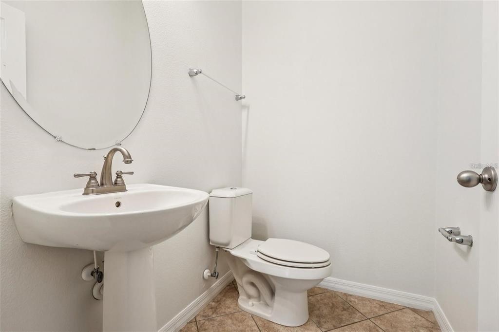 1126 Maumee Street Orlando, FL 32828 - Photo 12 of 21 a bathroom with a sink toilet and a mirror