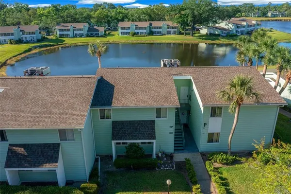 an aerial view of a house with a lake view