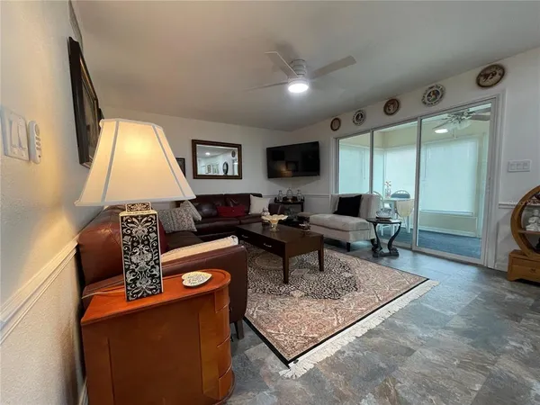 a view of a a dining room with furniture and kitchen