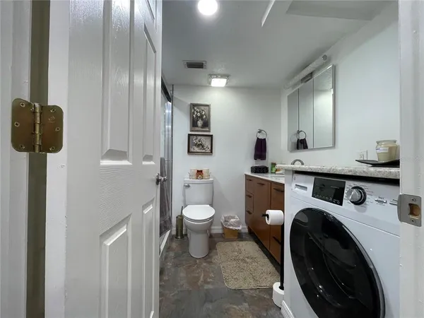 a bathroom with a toilet a sink and shower