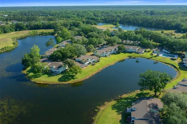 an aerial view of a house with a lake view