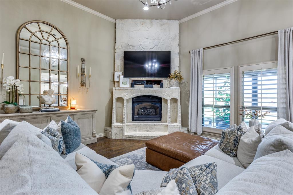 1150 Lone Star Road Bowie, TX 76230 - Photo 17 of 38 a living room with furniture a flat screen tv and a fireplace