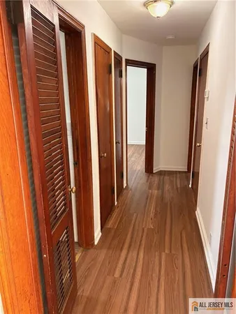 a view of a room with wooden floor and staircase