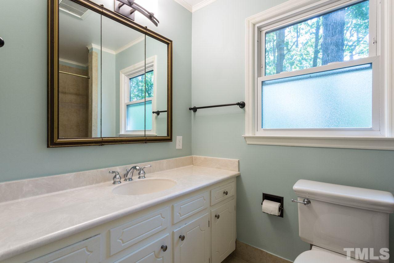 10205 Bushveld Lane Raleigh, NC 27613 - Photo 22 of 22 Features large updated tile shower with bench seat and tile flooring