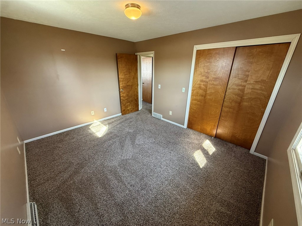 604 Harger Street Dover, OH 44622 - Photo 15 of 25 Unfurnished bedroom featuring a closet and carpet flooring