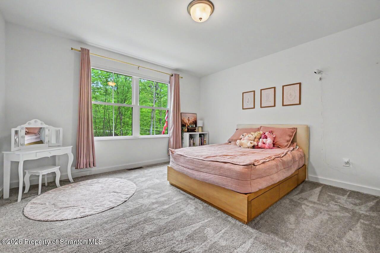 100 Highland Road Moscow, PA 18444 - Photo 57 of 85 a bedroom with a bed and a table