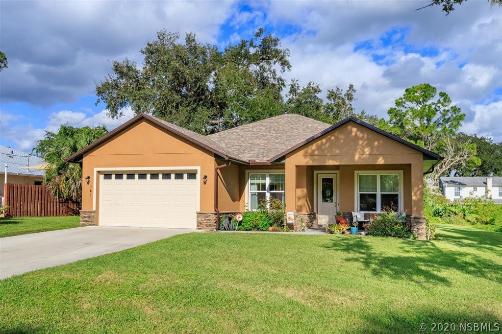 141 Poinciana Road Edgewater, FL 32141 - Photo 1 of 26 front view of a house with a yard