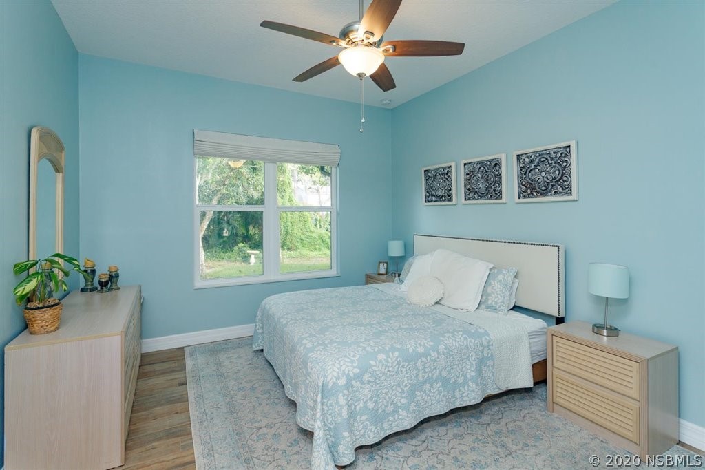 141 Poinciana Road Edgewater, FL 32141 - Photo 11 of 26 a bedroom with a bed and a chandelier