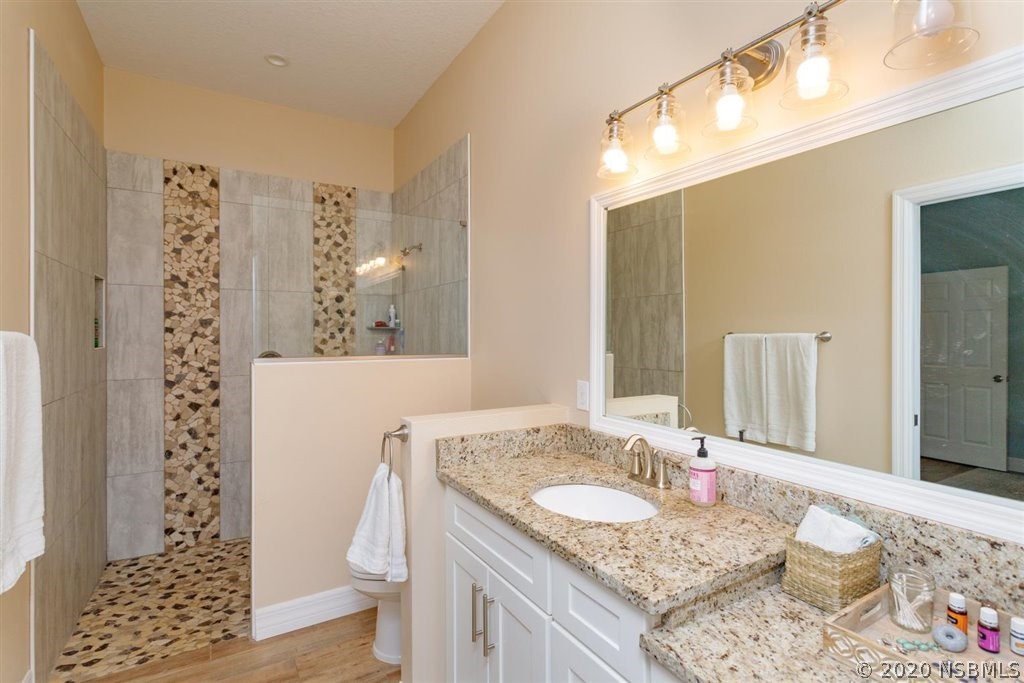 141 Poinciana Road Edgewater, FL 32141 - Photo 12 of 26 a bathroom with a granite countertop sink and a mirror