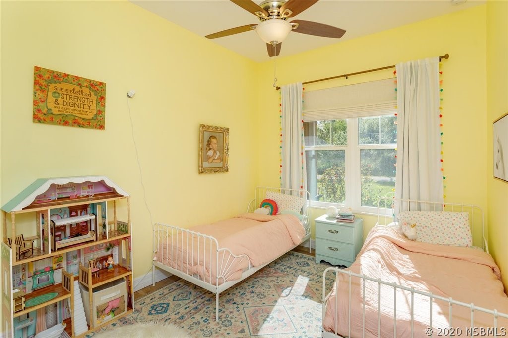 141 Poinciana Road Edgewater, FL 32141 - Photo 13 of 26 a spacious bedroom with a bed and a window