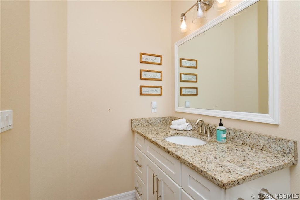 141 Poinciana Road Edgewater, FL 32141 - Photo 14 of 26 a bathroom with a granite countertop sink and a mirror