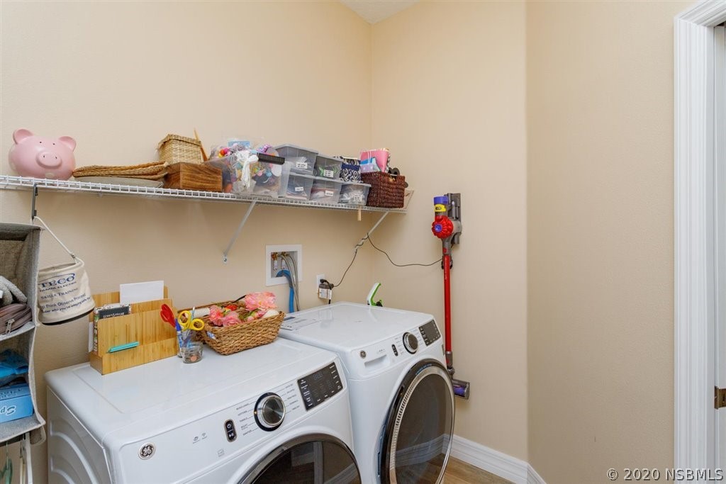 141 Poinciana Road Edgewater, FL 32141 - Photo 17 of 26 a utility room with dryer and washer