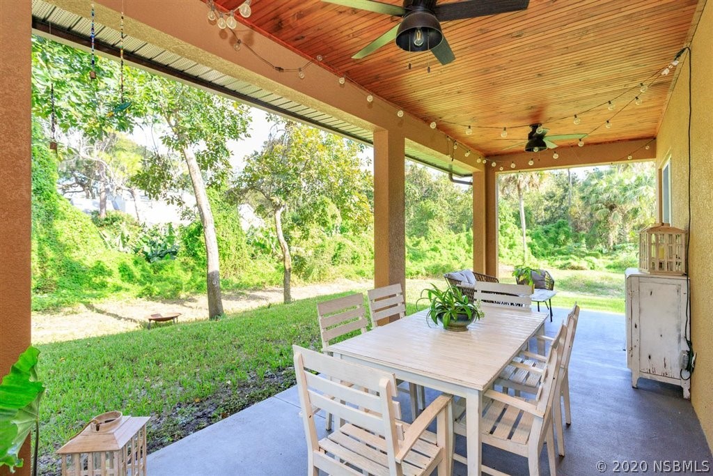 141 Poinciana Road Edgewater, FL 32141 - Photo 19 of 26 a view of a patio with a backyard