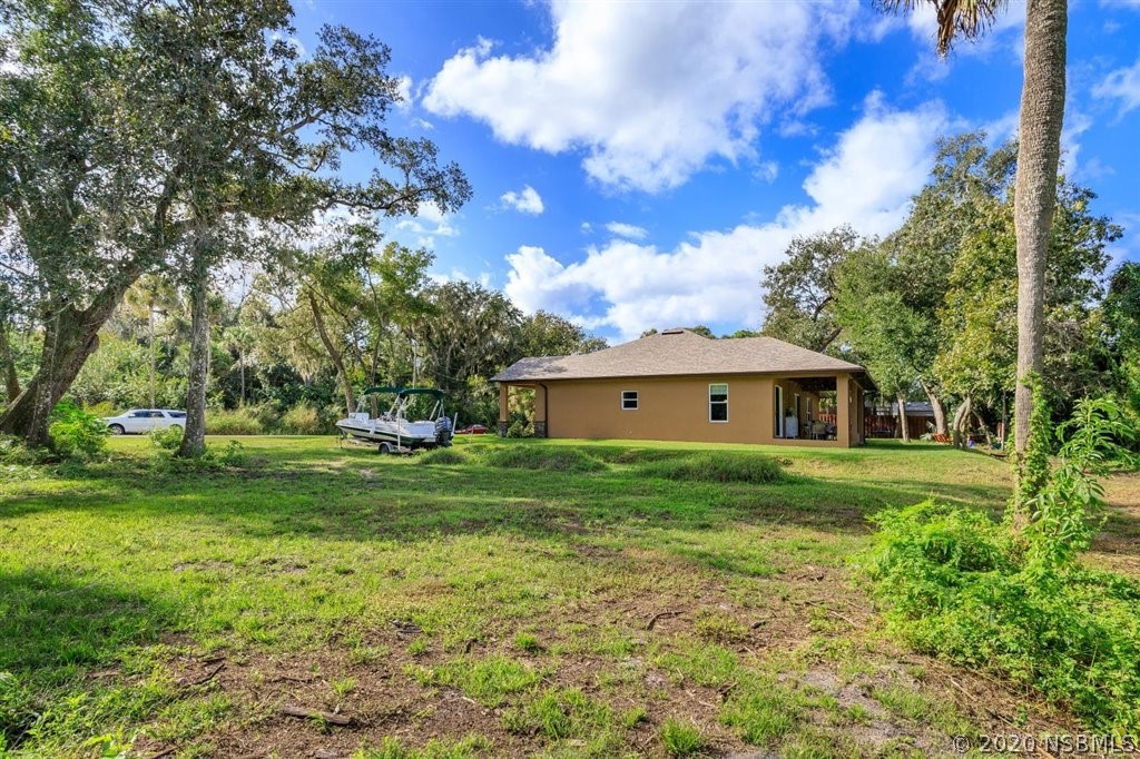 141 Poinciana Road Edgewater, FL 32141 - Photo 24 of 26 a view of a big yard with a house