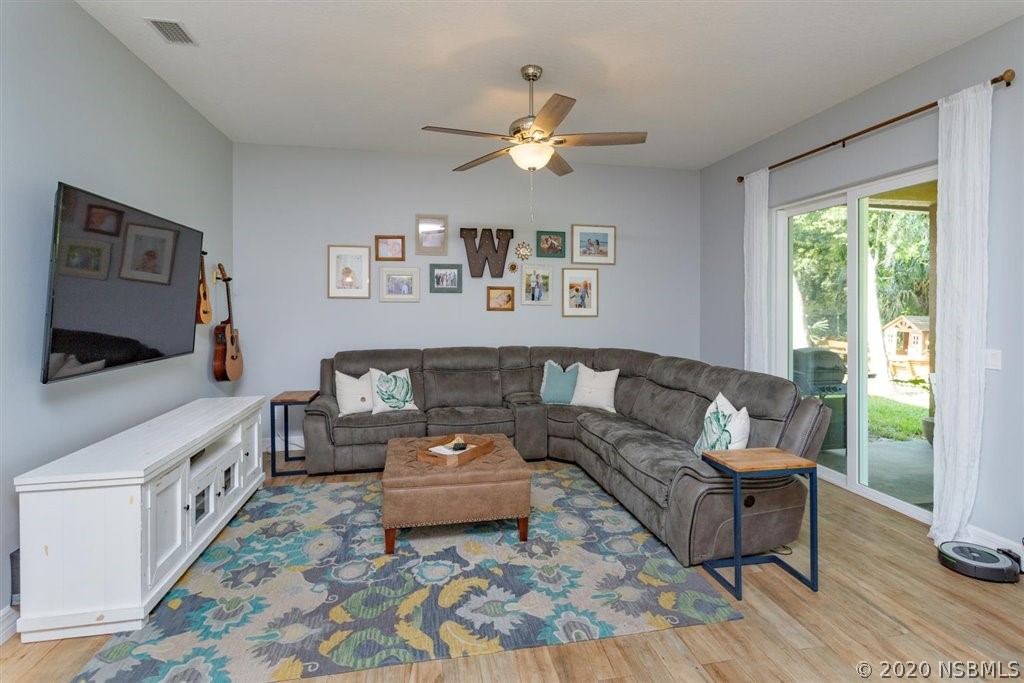 141 Poinciana Road Edgewater, FL 32141 - Photo 5 of 26 a living room with furniture and a flat screen tv