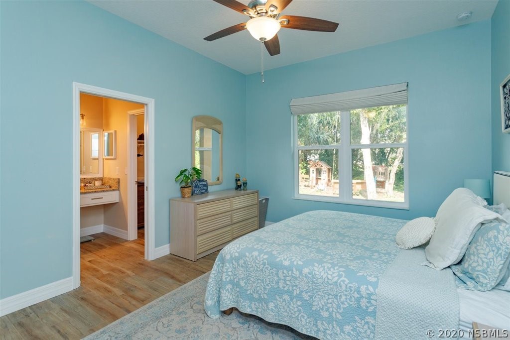 141 Poinciana Road Edgewater, FL 32141 - Photo 10 of 26 a bedroom with a bed and a dresser
