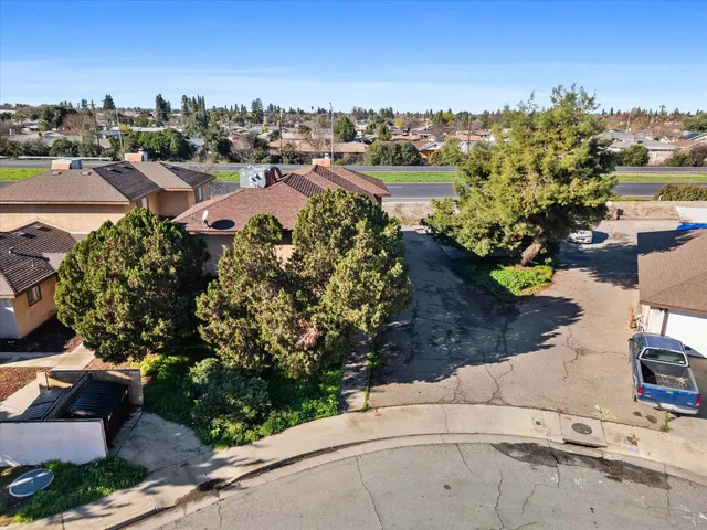 an aerial view of a house with a garden and lake view