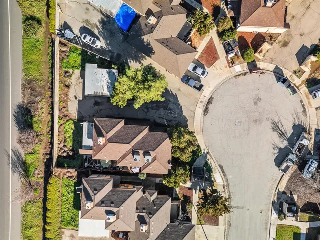 an aerial view of residential houses with outdoor space
