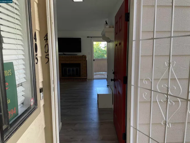 a view of a hallway view with wooden floor and staircase