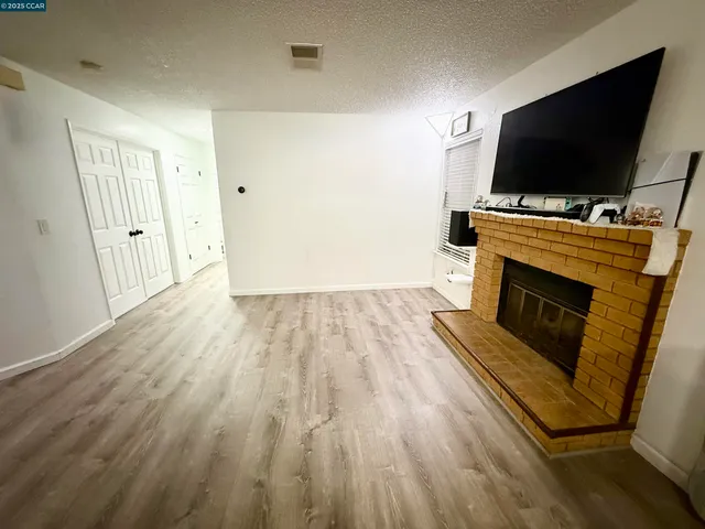 a living room with a flat screen tv and a fireplace