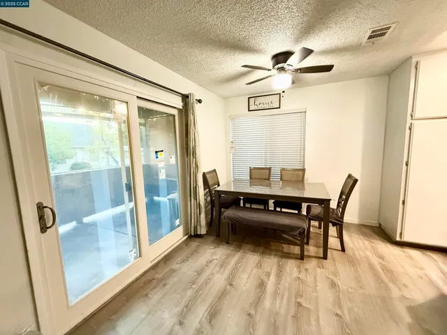 a dining room with wooden floor and furniture