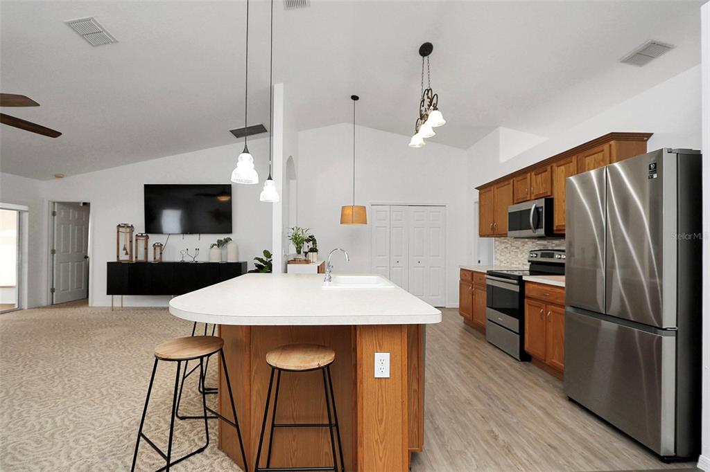 10648 Southwest 38th Avenue Ocala, FL 34476 - Photo 11 of 52 a kitchen with stainless steel appliances a stove refrigerator sink and microwave
