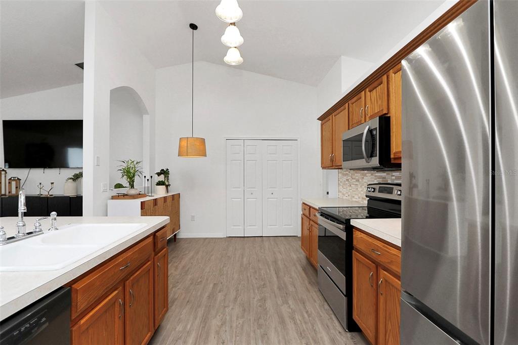 10648 Southwest 38th Avenue Ocala, FL 34476 - Photo 12 of 52 a kitchen with stainless steel appliances a stove microwave and sink