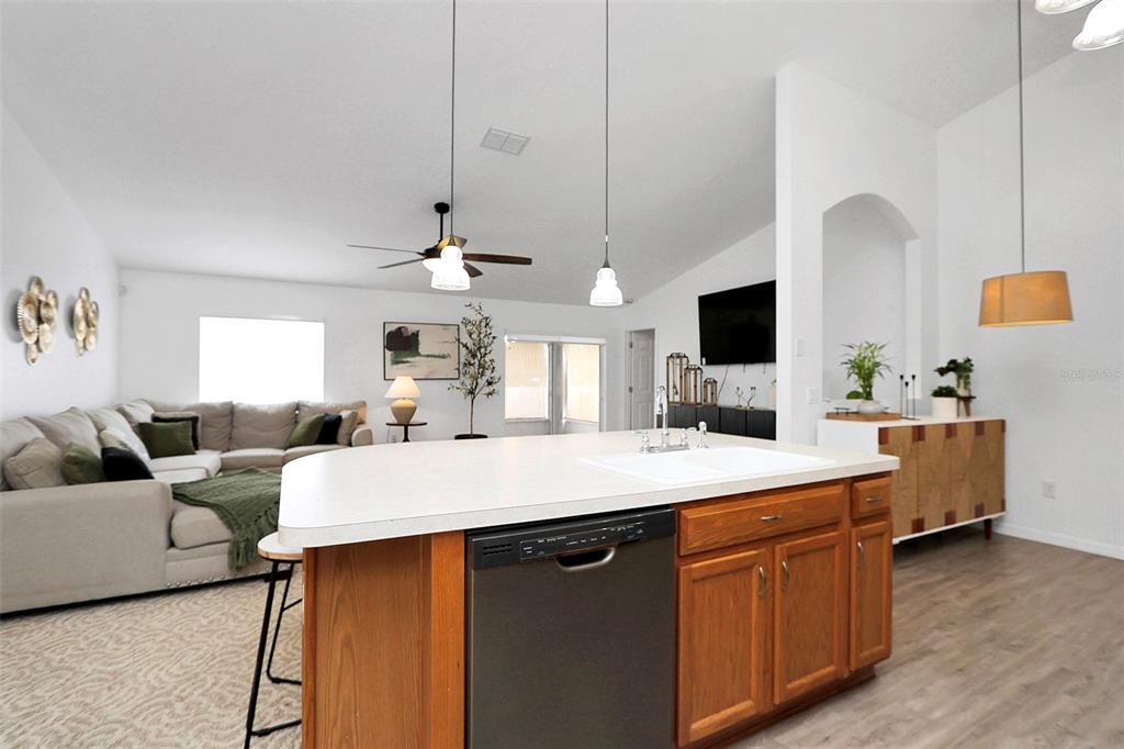 10648 Southwest 38th Avenue Ocala, FL 34476 - Photo 13 of 52 a room with a chandelier furniture and a flat screen tv