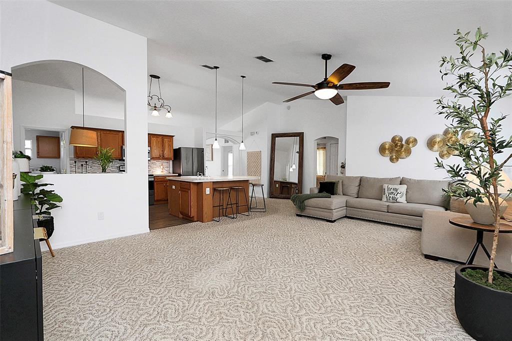10648 Southwest 38th Avenue Ocala, FL 34476 - Photo 21 of 52 a living room with furniture and a flat screen tv