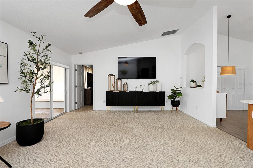 10648 Southwest 38th Avenue Ocala, FL 34476 - Photo 23 of 52 a living room with furniture and a flat screen tv