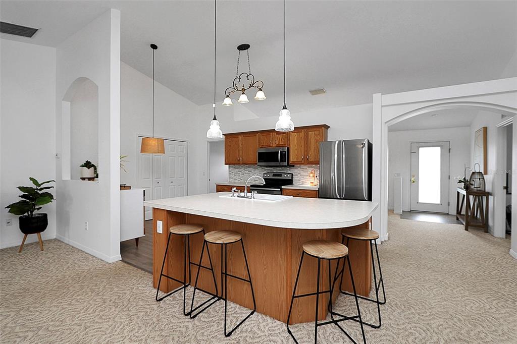10648 Southwest 38th Avenue Ocala, FL 34476 - Photo 24 of 52 a view of a dining room with furniture and a chandelier