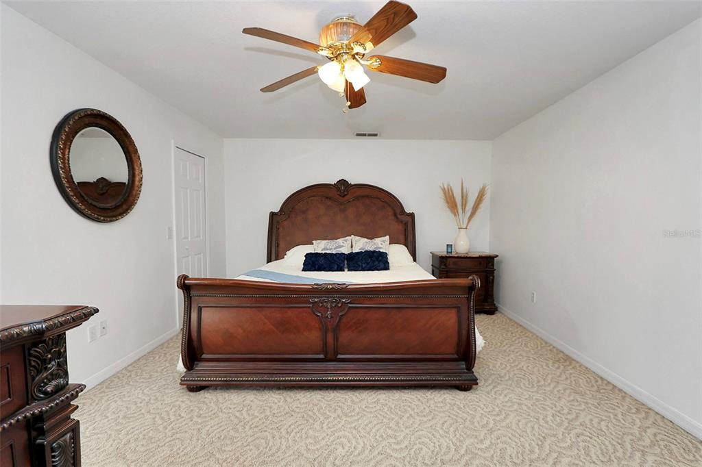 10648 Southwest 38th Avenue Ocala, FL 34476 - Photo 28 of 52 a living room with a couch and a chandelier