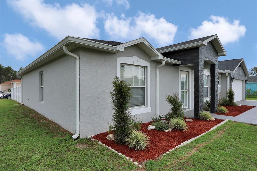 10648 Southwest 38th Avenue Ocala, FL 34476 - Photo 3 of 52 a house with garden in front of it