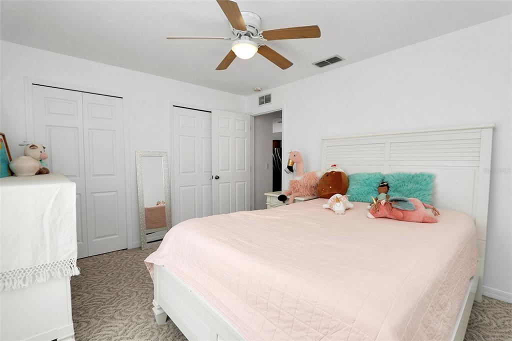 10648 Southwest 38th Avenue Ocala, FL 34476 - Photo 35 of 52 a bedroom with a bed and a chandelier