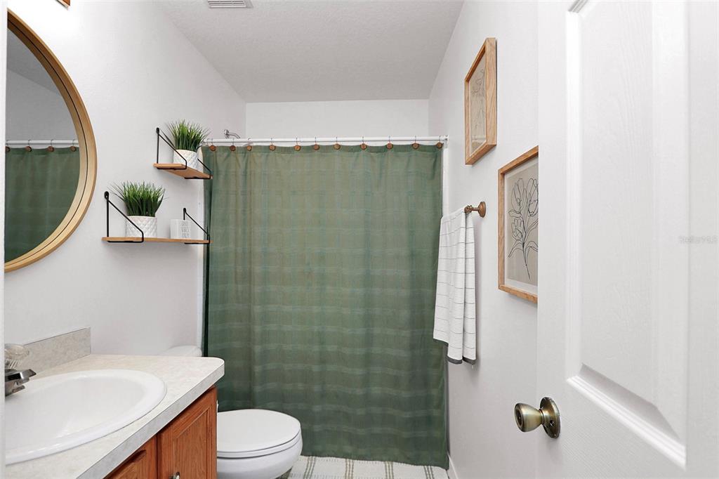 10648 Southwest 38th Avenue Ocala, FL 34476 - Photo 36 of 52 a bathroom with a sink toilet and shower