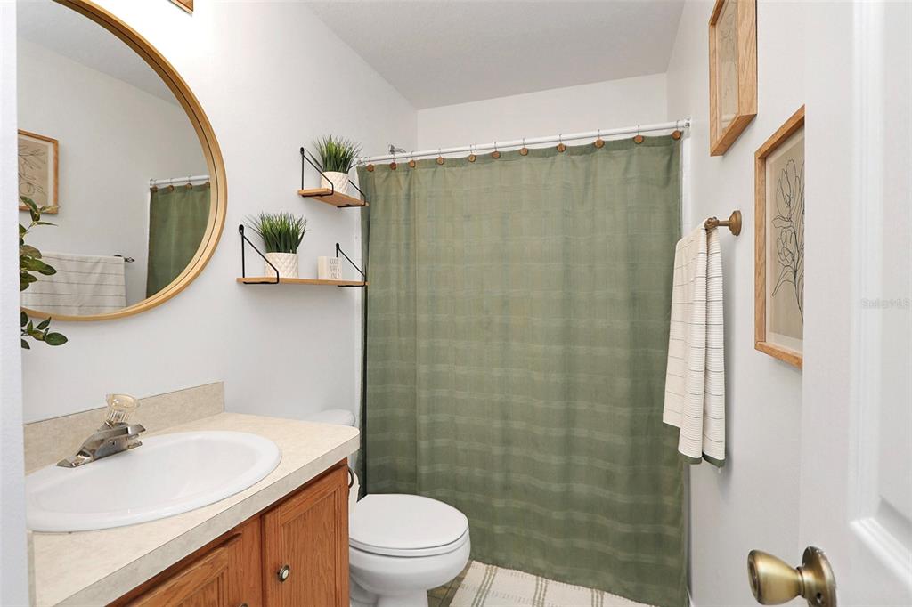 10648 Southwest 38th Avenue Ocala, FL 34476 - Photo 38 of 52 a bathroom with a sink vanity mirror and toilet