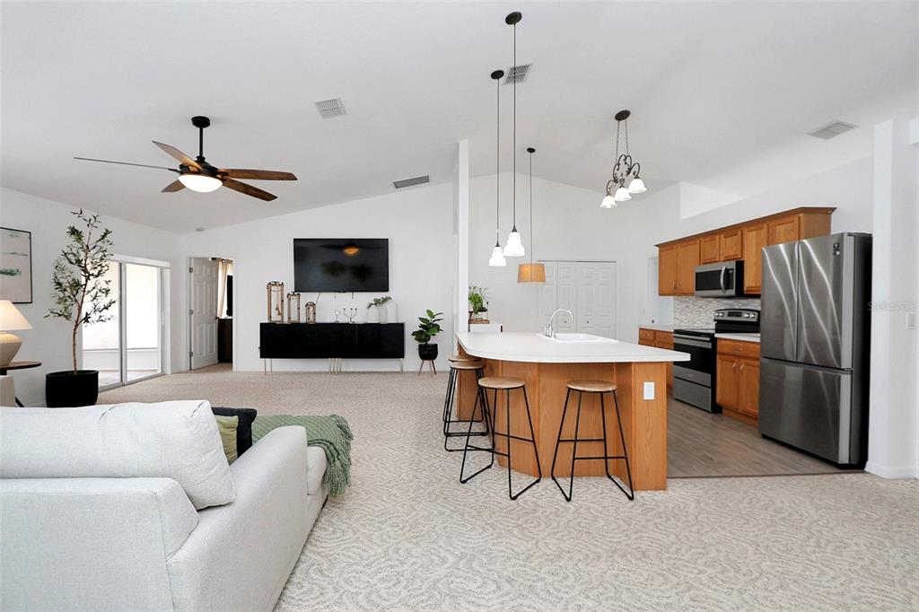 10648 Southwest 38th Avenue Ocala, FL 34476 - Photo 41 of 52 a living room with furniture a fireplace and a flat screen tv