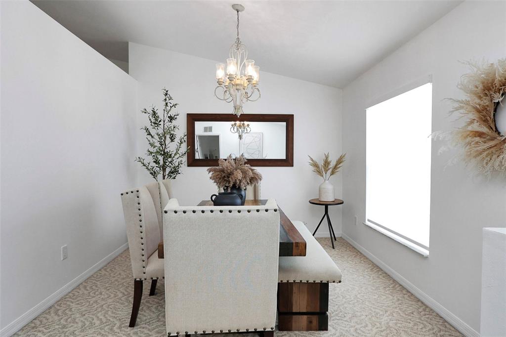 10648 Southwest 38th Avenue Ocala, FL 34476 - Photo 5 of 52 a view of a dining room with furniture and chandelier