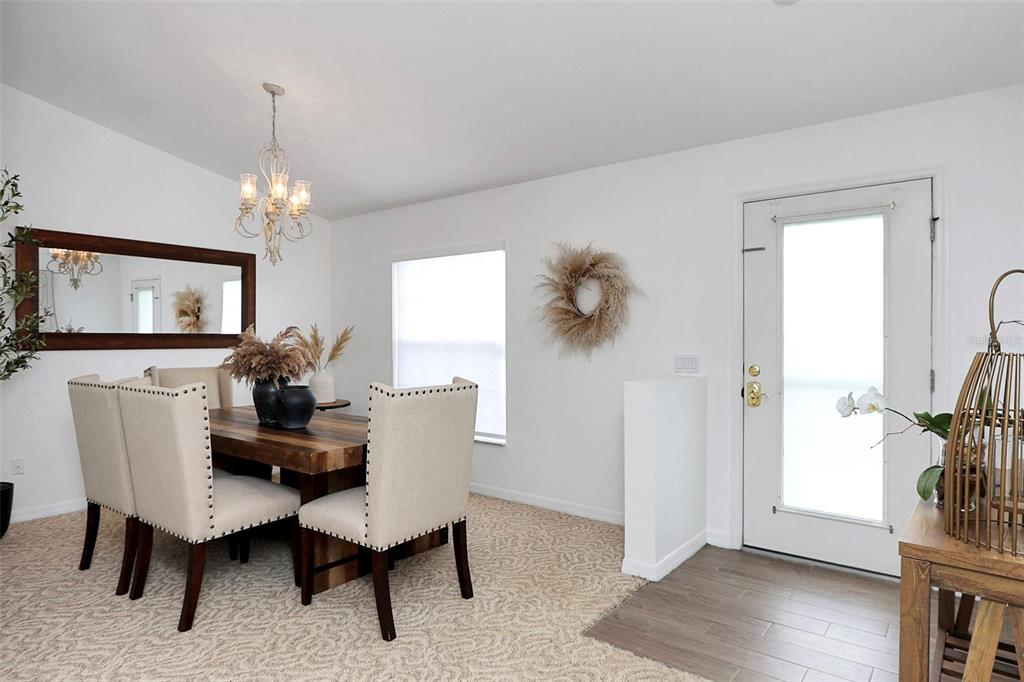 10648 Southwest 38th Avenue Ocala, FL 34476 - Photo 6 of 52 a living room with furniture a dining table and a window
