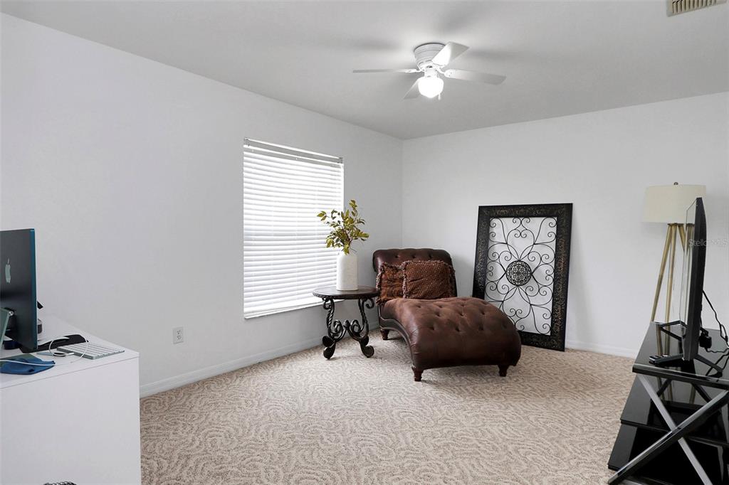 10648 Southwest 38th Avenue Ocala, FL 34476 - Photo 8 of 52 a living room with furniture and a flat screen tv