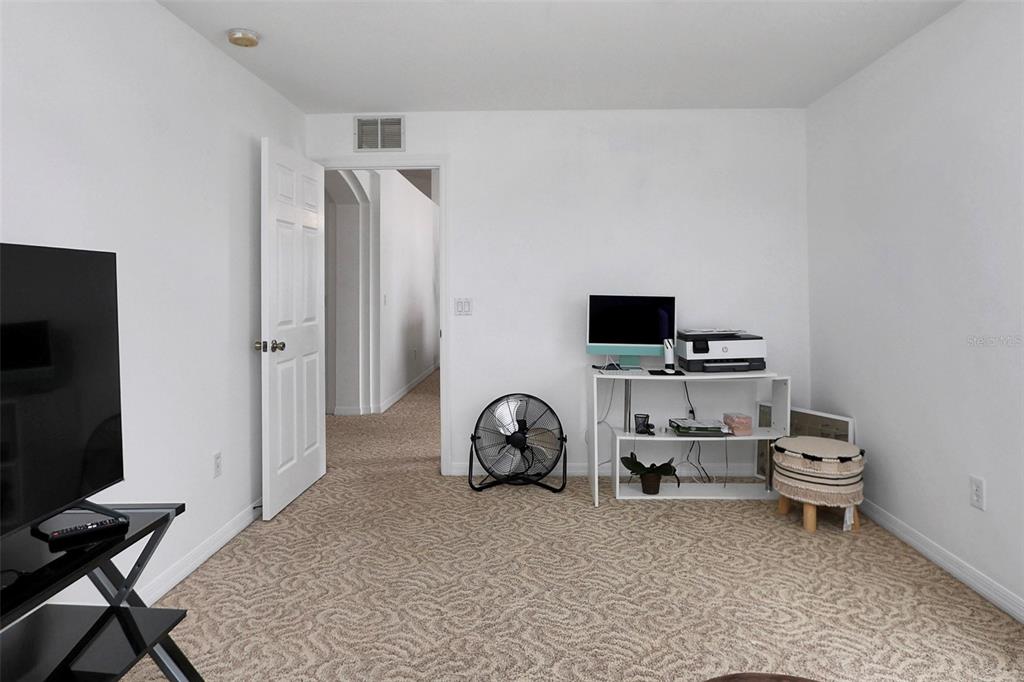 10648 Southwest 38th Avenue Ocala, FL 34476 - Photo 9 of 52 a view of a workspace with furniture and a flat screen tv