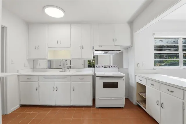 a bathroom with a double vanity sink a mirror a bathtub and a shower