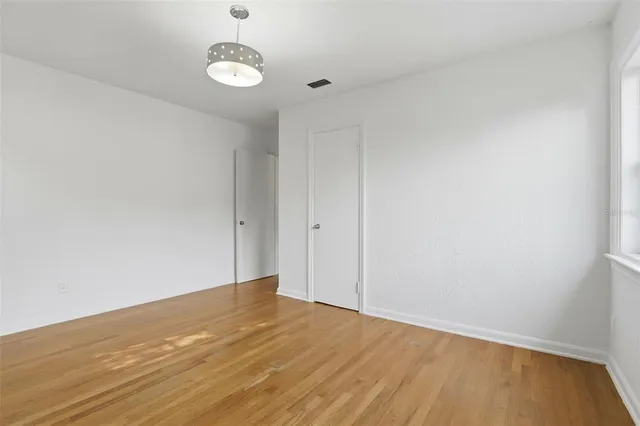 a bathroom with a sink mirror toilet and next to a window