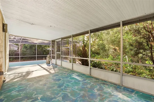 a view of a room with a wooden fence and a tree