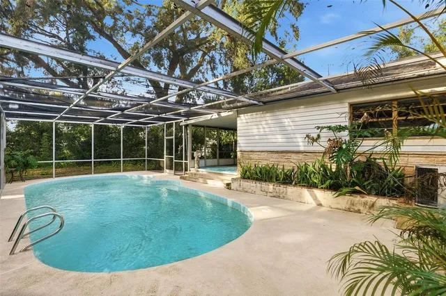a backyard of a house with yard and outdoor seating
