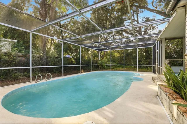 a backyard of a house with table and chairs